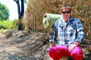 Paul Reynolds on the scorched front boundary of his Reynolds Road property, just metres from his house.