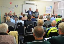 Men unite outside the shed