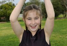 Pint-sized footy player kicking goals